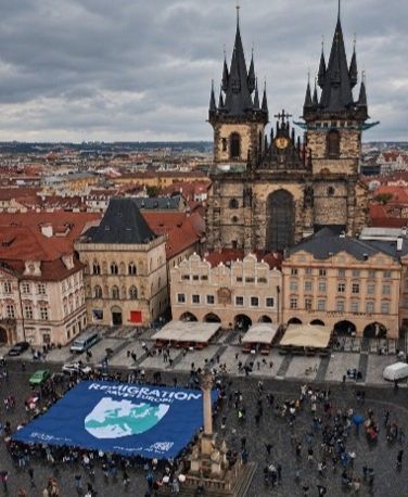 Aerial view of Prague square with large blue banner.